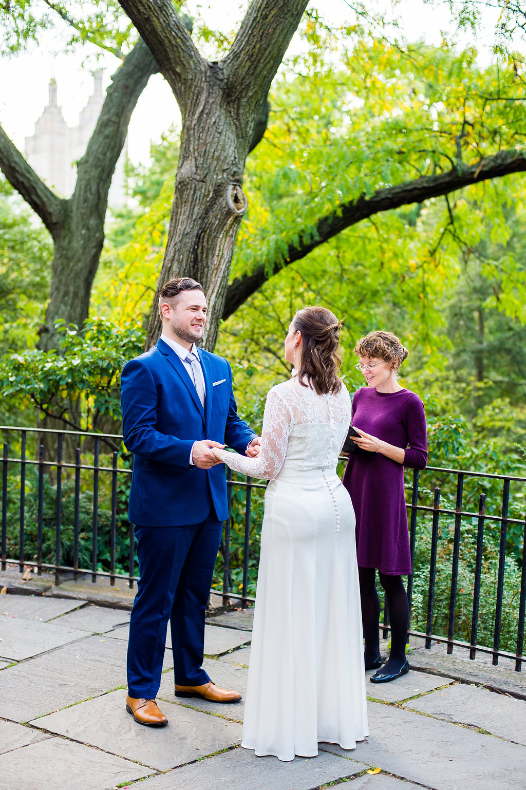 Wedding Officiant marries couple on the balcony by the Shakespeare Garden in Central Park.